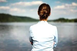 woman looking at lake